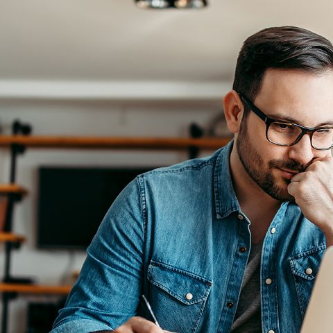 A person in a denim shirt sits at a desk, participating in MS Excel course